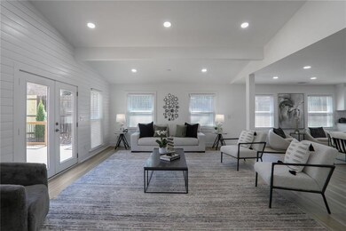 Living room featuring vaulted ceiling with beams, wood finished floors, french doors, and recessed lighting