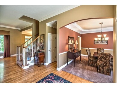 Elegant Arched Entryways Foyer with Hardwood Floor