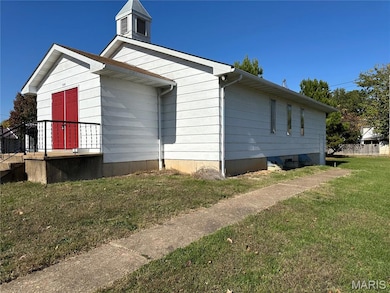 View of property exterior with a yard