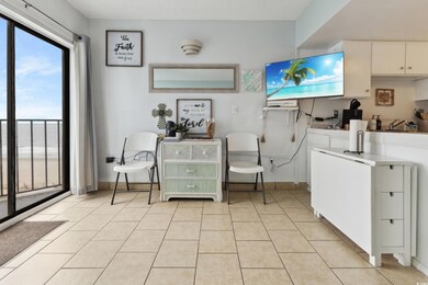 Laundry area with light tile patterned floors
