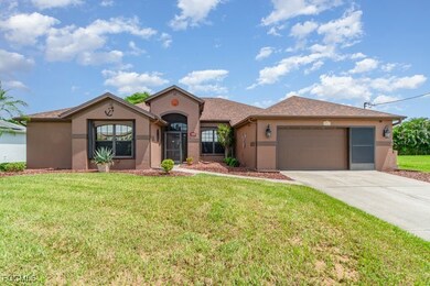 Mediterranean / spanish home with stucco siding, driveway, a front lawn, and an attached garage