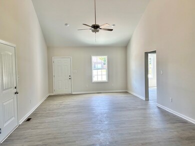 Garage entrance to the left, front door entrance, and 2 bedrooms and bath to the right.