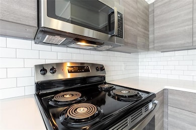 Kitchen with tasteful backsplash and stainless ste