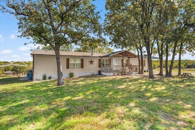 View of front of property with a front lawn and a wooden deck