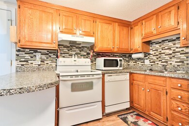 Kitchen featuring backsplash, light hardwood / woo