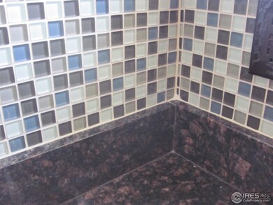 Glass backsplash in Kitchen with slab granite coun