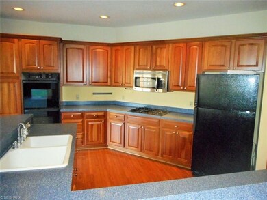 Wood floored kitchen with a dining area to the sid