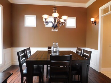 A formal dining room provides ample seating for entertaining guests or for family dinners.