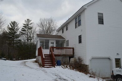 Back left of house with 3 season porch and open de