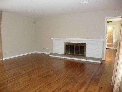 Living Room. Beautiful hardwood and fireplace.