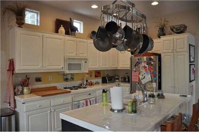 Custom tile frames this airy European kitchen with