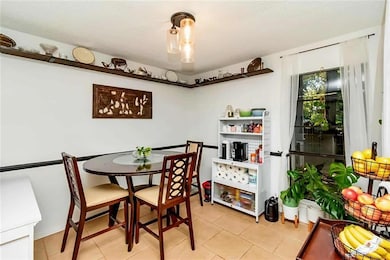 Dining space with light tile patterned floors