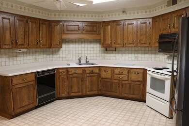 1Z7A2526.  Large kitchen with 3 walls of cabinets, eat-in area