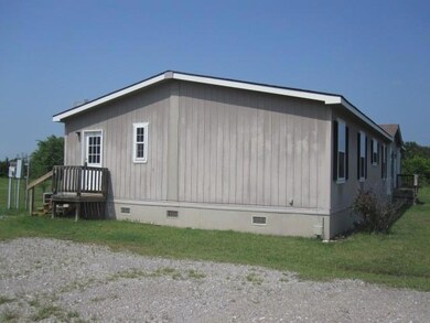 View of home's exterior with a yard