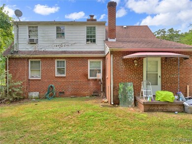 Rear view of house featuring a lawn