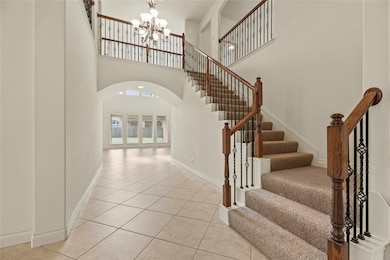 Gorgeous staircase with wrought iron spindles.