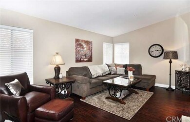 Neutral Paint and Warm Laminate Wood Floors