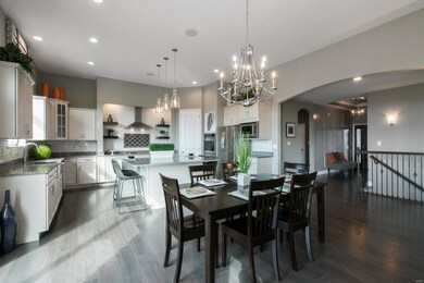 Tall 11' ceilings and custom lighting continue in the breakfast room and kitchen!