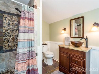The tile and stone walk in shower in the master ba