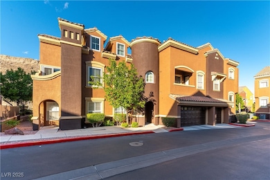 View of property featuring driveway and a garage