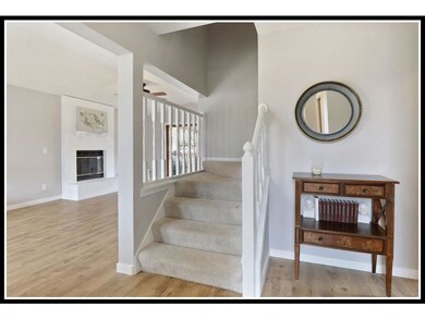 Welcoming foyer open to living room on the left an