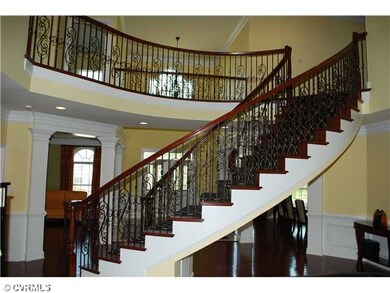 Foyer - Custom designed sweeping staircase with an