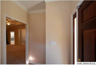 FOYER WITH WOOD FLOOR AND MAHOGANY DOOR.