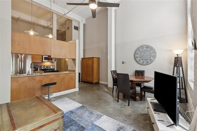 This view of the living room shows the open kitche
