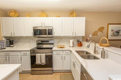 Kitchen with light tile patterned flooring, sink, 