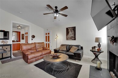 Living room featuring ceiling fan, carpet flooring