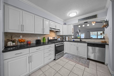 Updated kitchen is located just off the foyer & offers stainless appliances, granite countertops, & tile flooring. Refrigerator included!