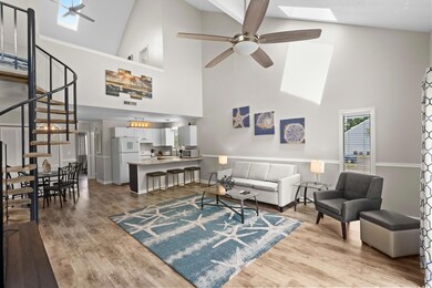 Living room featuring ceiling fan, high vaulted ce