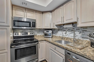 Kitchen offers light wood cabinets and granite cou