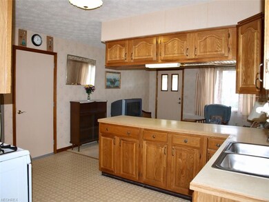View from side door through kitchen into living ro