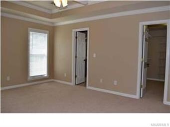 The master bedroom has a trey ceiling with a ceili