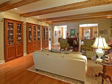 The limestone fireplace adorns one side of the liv