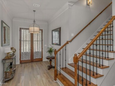 Foyer with hardwood / wood-style flooring, french 
