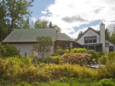 Rear view of the home with gardens...
