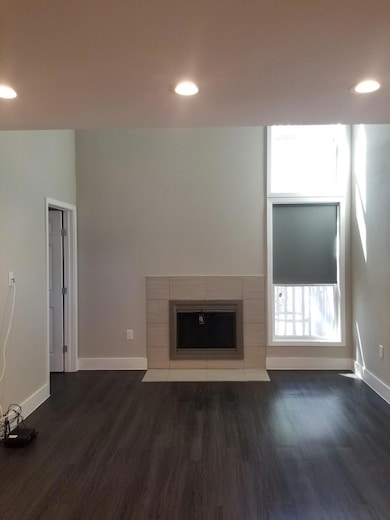 Unfurnished living room featuring dark wood finis