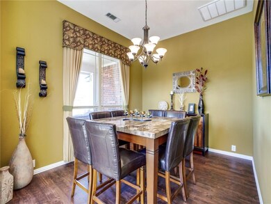 Formal off entry with rich laminate wood flooring 