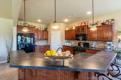 Guests can pull up a seat and visit with the cook while food is being prepared.  Full complement of GE Appliances including the built-in microwave (2 yrs old), Gas Range & Oven, Dishwasher (newer), and Fridge stay with the home.