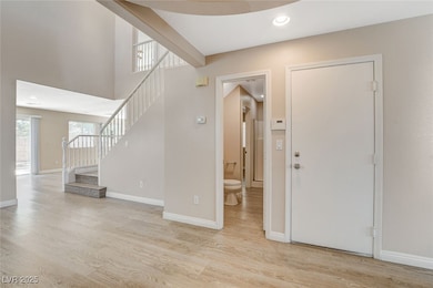 Foyer featuring light wood finished floors, stairw