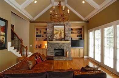 The den features vaulted ceiling, fireplace, built-ins & opens to a fabulous deck!
