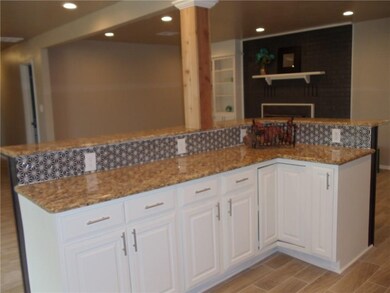 View of kitchen looking into living room. Open con