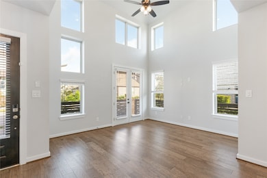 Look at this living room! Lots of natural lights,  2 story high ceiling and access to your private front porch.