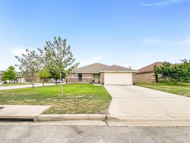 Single story home featuring a front yard, an atta