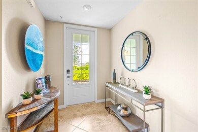 Entryway with light tile patterned flooring and ba