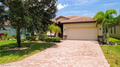 View of front of house with decorative driveway, a