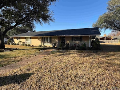 Ranch-style home with a front lawn