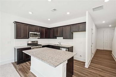 Granite and Stainless Appliances with Stained Cabinets